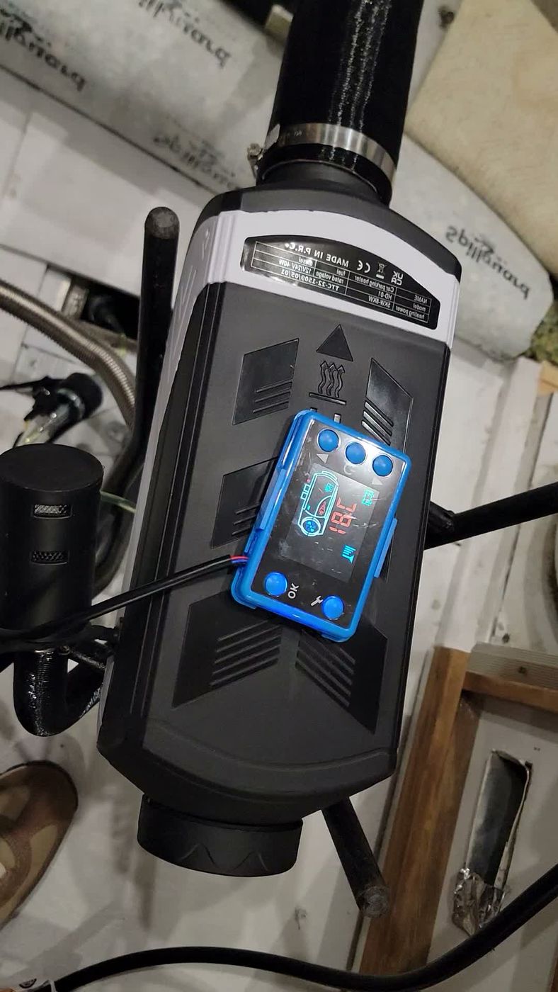 The diesel air heater unit with its blue controller resting on top.