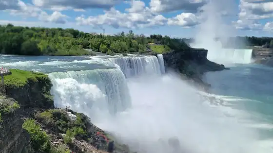 Niagara Falls spilling over the brink with mist rising