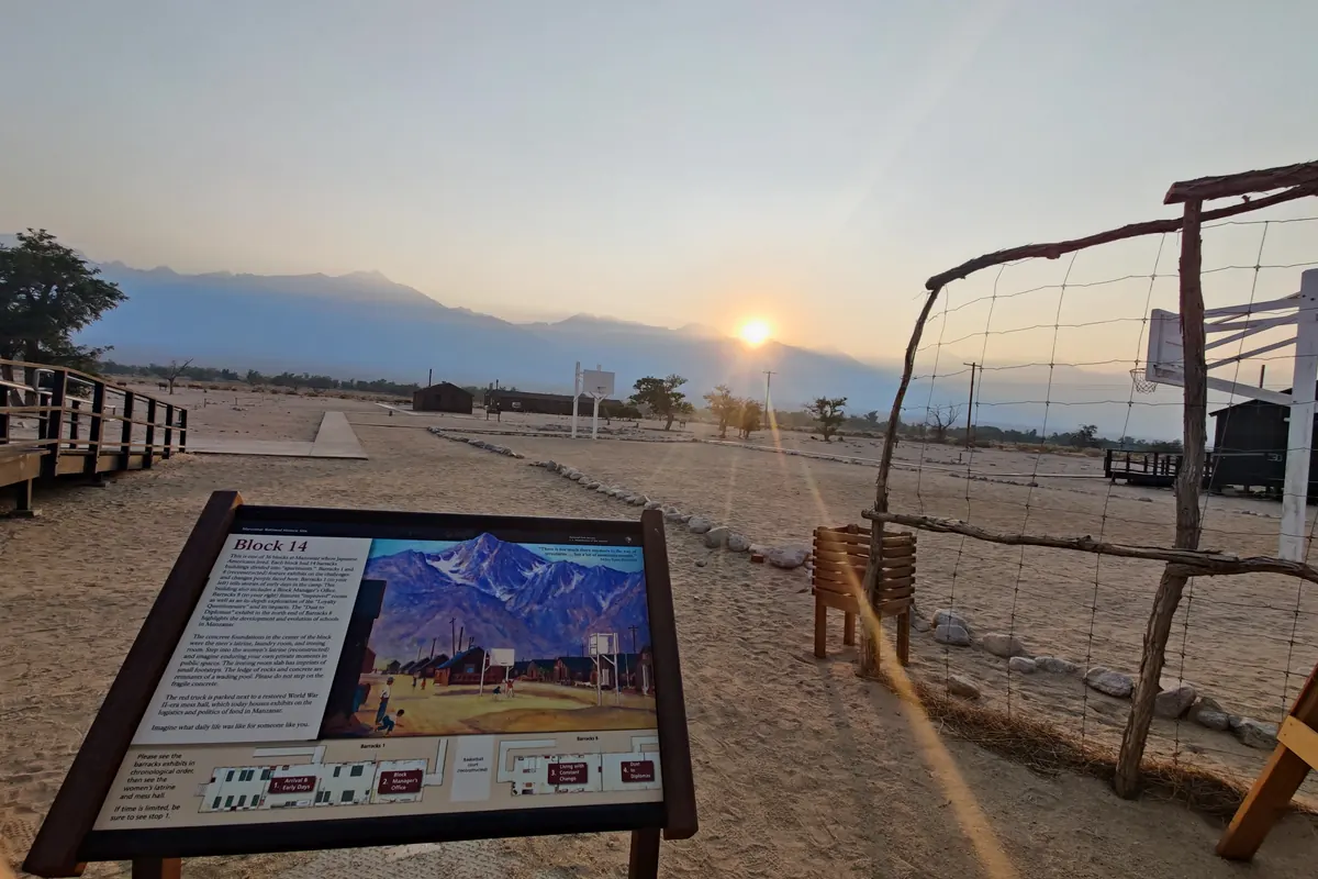 The Block 14 interpretive sign at Manzanar with the Sierra Nevada behind it at sunset