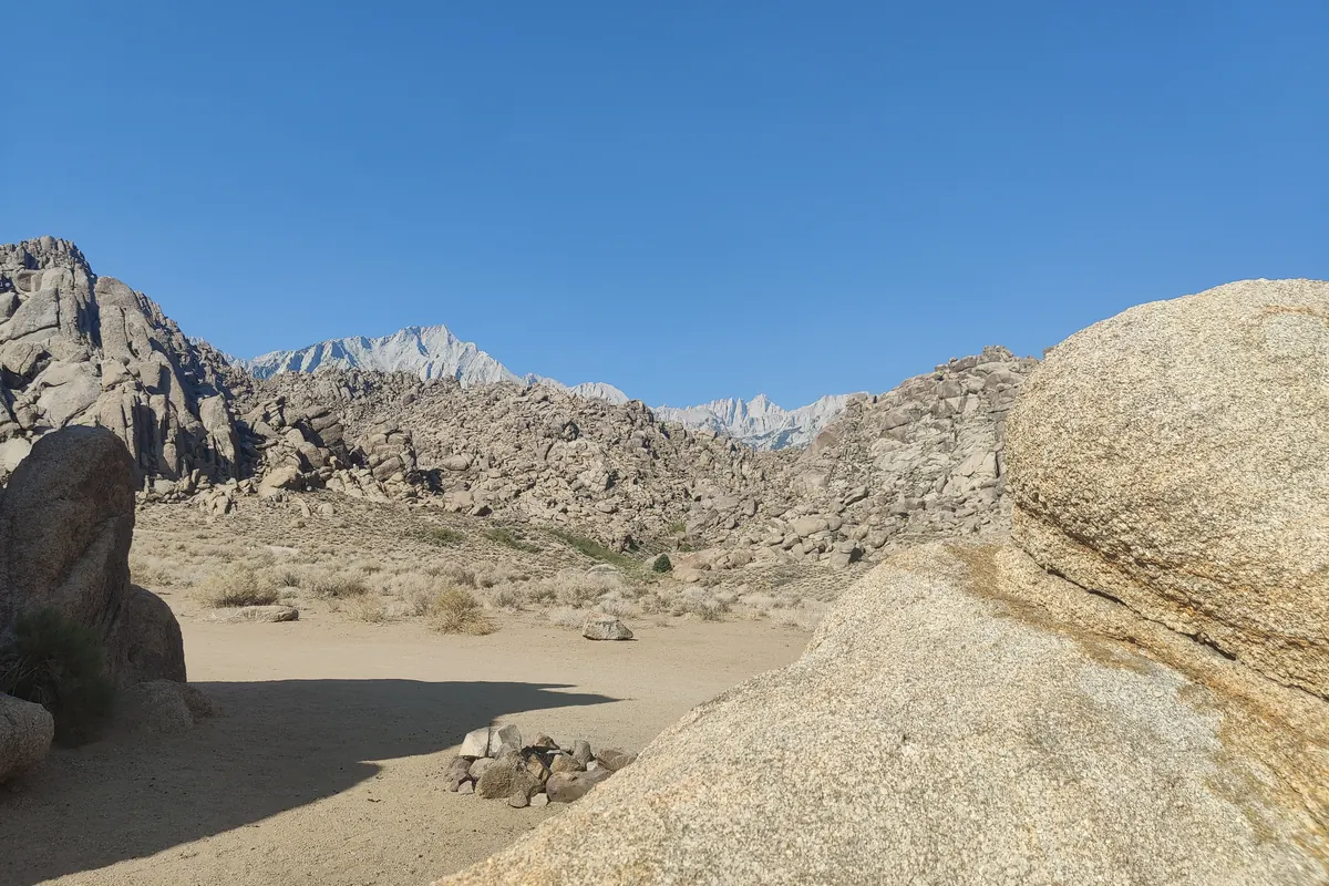 Rounded granite boulders in the Alabama Hills with the Sierra Nevada crest behind