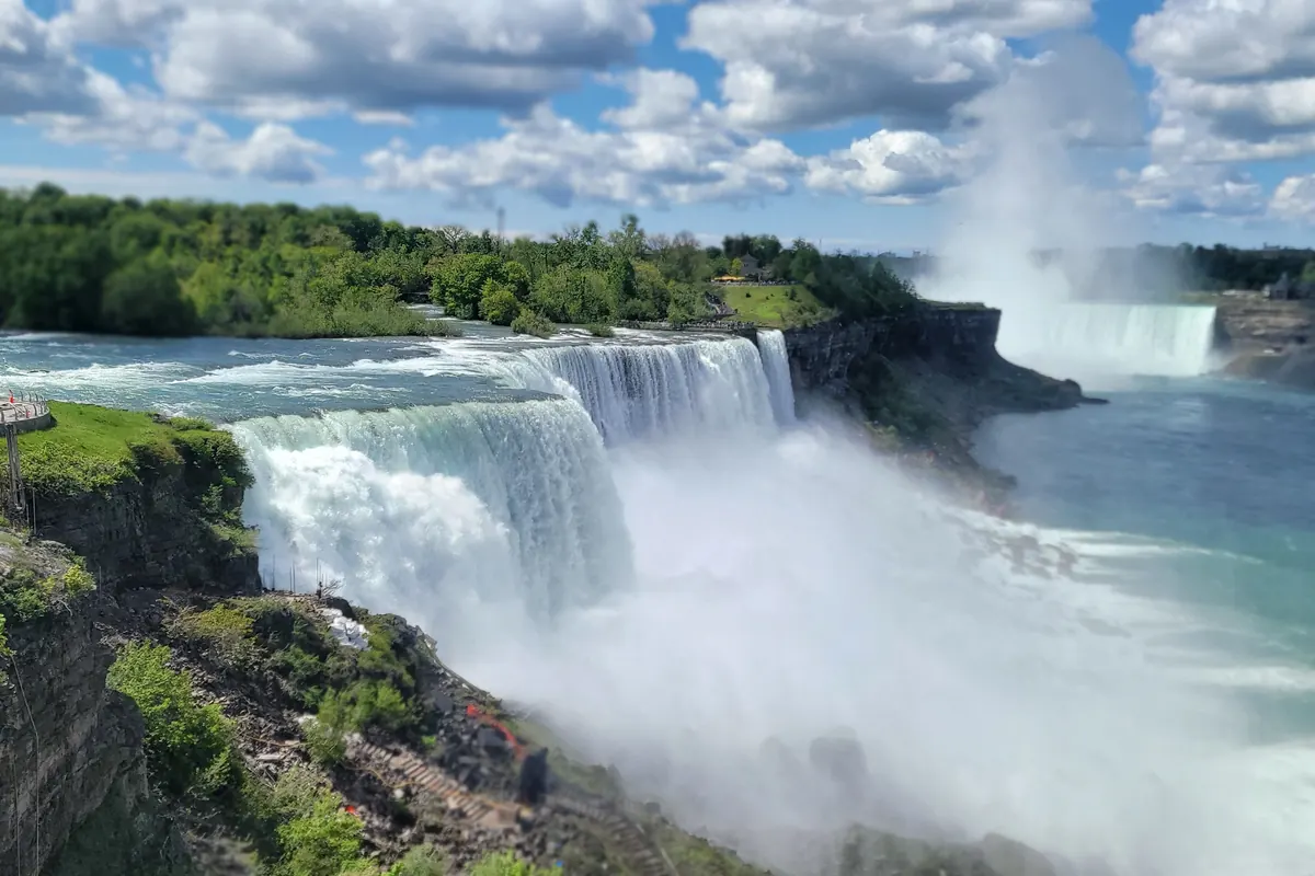 Niagara Falls spilling over the brink with mist rising