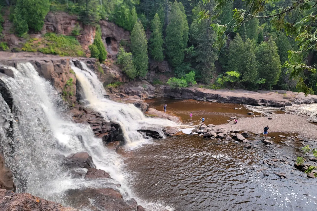Gooseberry Falls pouring over dark lava rock with the river pool below