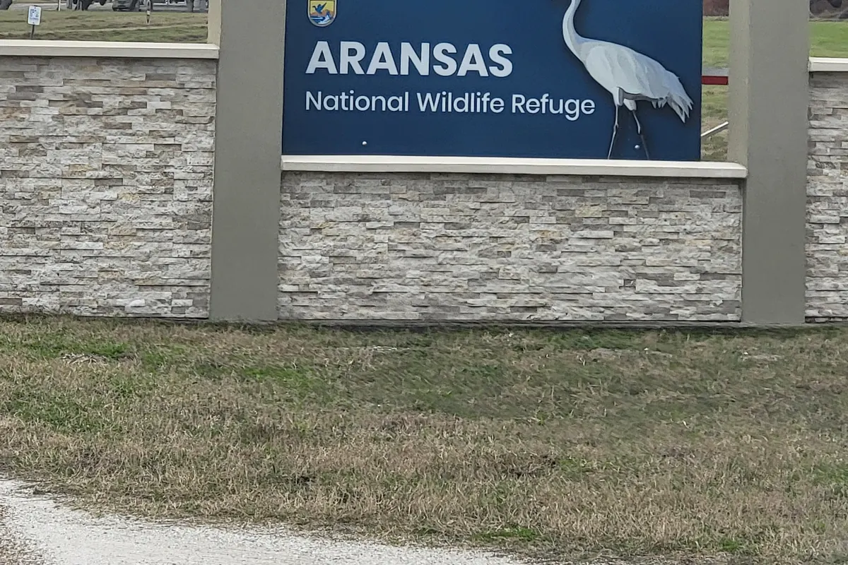 The Aransas National Wildlife Refuge entrance sign and a coastal marsh