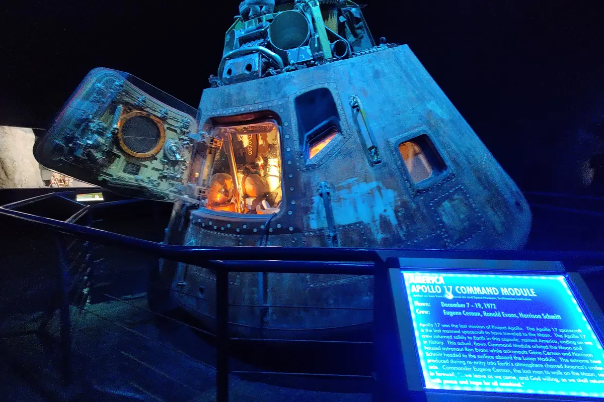 An Apollo capsule display and the space shuttle on its carrier aircraft at Johnson Space Center