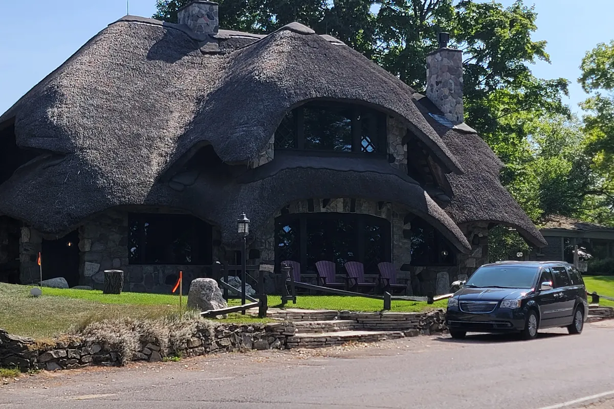 A stone mushroom house with a thatched-look roof in Charlevoix