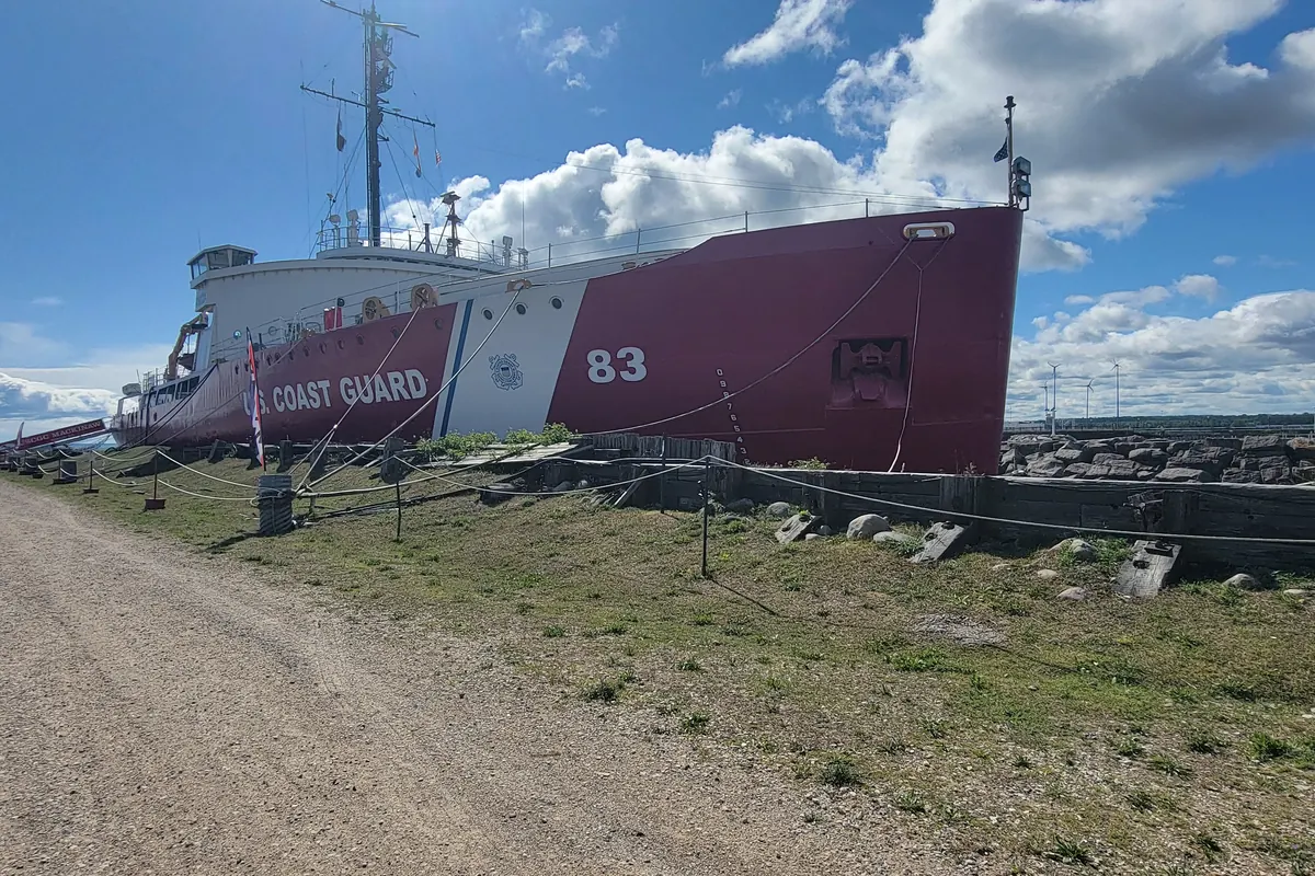 The red-hulled icebreaker Mackinaw moored at the dock in Mackinaw City