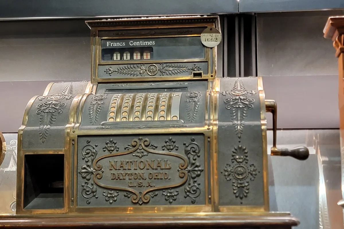 An ornate brass National cash register marked Dayton, Ohio