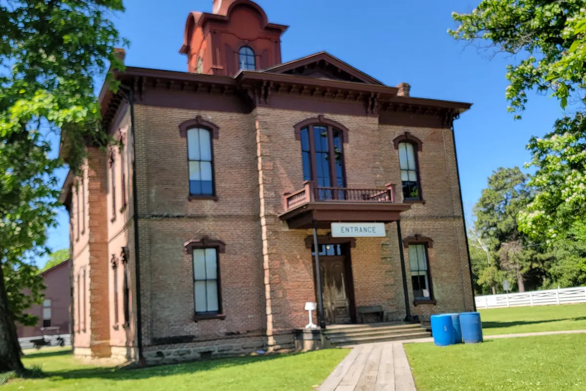 The brick courthouse and the James Black blacksmith shop plaque at Historic Washington State Park